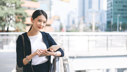 Business asian woman front face hand holding digital tablet working in city modern lifestyle