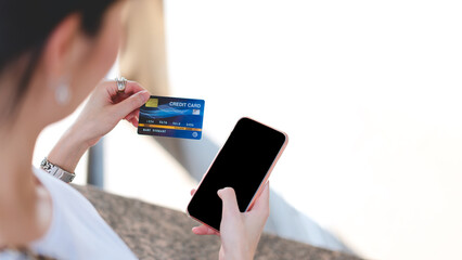 Woman hand using creadit card and smartphone shopping via online application media for cashless mockup blank screen