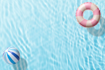 水面に浮かんだ浮き輪とビーチボール