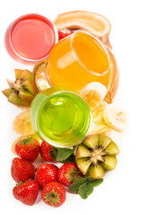 banana , kiwi and strawberry jelly in glasses with fresh berries and fruits on a white background