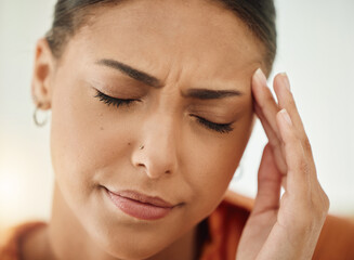 Face, woman and pain of headache from stress, mental health and sick of fatigue. Closeup of sad female person with depression, anxiety or frustrated with brain fog, debt and crisis of burnout