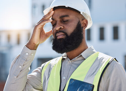 Construction, man and worker with headache, stress of building renovation and civil engineering mistake. Tired face of confused African contractor in burnout, crisis and industrial problem in city