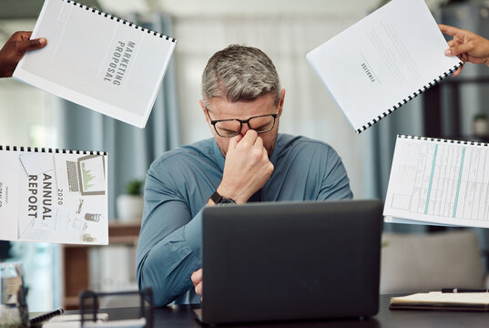 Business man, stress and overwhelmed with headache, documents and staff hands in busy office. CEO, manager or tired boss with laptop, paperwork and burnout with employee group at marketing agency
