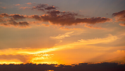 Obraz premium Evening, Colorful sunset sky background in Golden Sky Hour with Romantic Orange, Yellow sunlight clouds Summer season