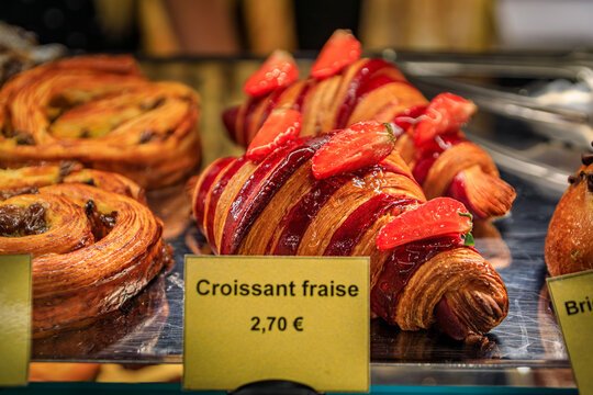 Freshly baked French glazed strawberry croissant at breakfast at an artisanal bakery in the medieval town of Saint Paul de Vence, South of France