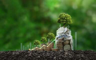 The tree grows on stacked coins on the soil. Renewable energy generation is essential for the...