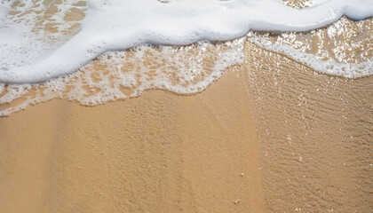Sand Beach Background with Sandy beautiful white foamy and wave from the sea, beach top view seaside.