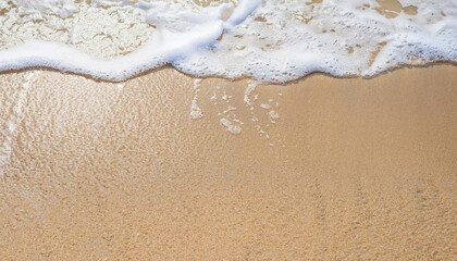 Sand Beach Background with Sandy beautiful white foamy and wave from the sea, beach top view seaside.