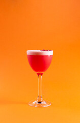 Red cocktail in a tall glass.