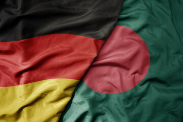 big waving realistic national colorful flag of germany and national flag of bangladesh .