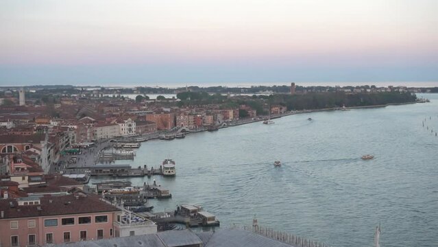 A port of a coastal city. The city of Venice from above. Aerial panoramic image of the sea and the city with its houses and boats at sunset