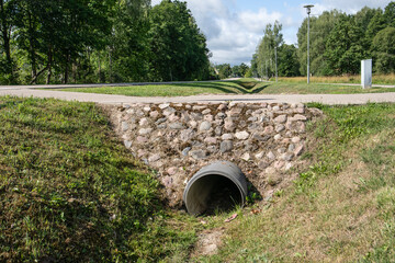 Trough the pipe. Stormwater and road infrastructure ditch