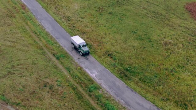 Military car Truck moving on the road. Ukraine Bakhmut Aerial shot