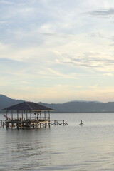 Wooden bridge on the lake at sunset, Gorontalo, Indonesia