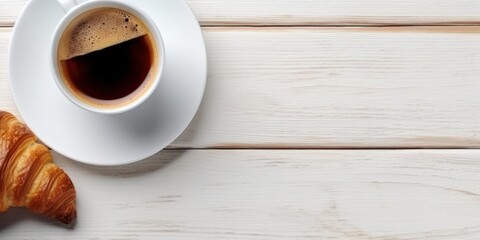 Obraz premium a cup of coffee and a croissant on a white wooden table, created by Generative AI