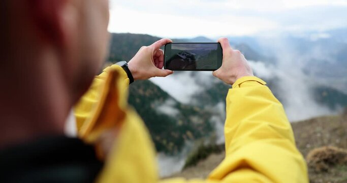 Man photographing beautiful mountains on mobile phone camera closeup 4k movie slow motion. Beautiful nature memories concept