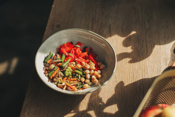 Woman holding plate with vegan or vegetarian food. Healthy plant based diet. Healthy dinner or lunch. Buddha bowl with fresh vegetables. Healthy eating