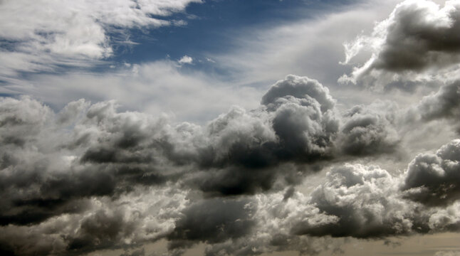 dark clouds over the blue sky