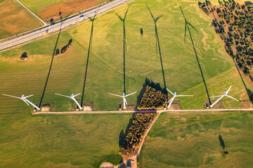 Alternative energy wind turbine in green agriculture field at sunset. Windmill for electric power with clean and Renewable Energy. Wind power station on the field. Concept of alternative energy, Spain