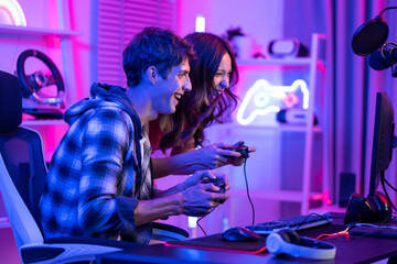 Caucasian Esport couple gamer playing online video game on computer. 