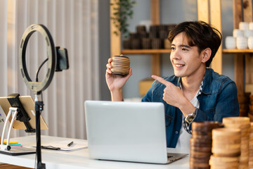 Asian handsome man sell vase product online live streaming at home. 