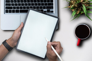 Male hands working on modern laptop. Office desktop on white background.