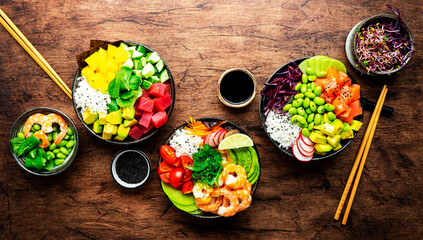 Poke bowl set with tuna, salmon, shrimp, avocado, mango, white rice and other ingredients. Soy...