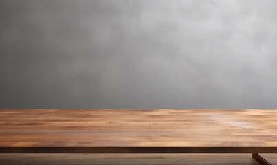 empty wooden table against a background of a clean, gray wall