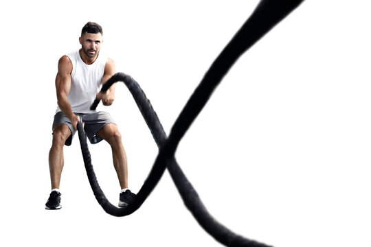 Athletic young man with battle rope doing exercise in functional training on a transparent background