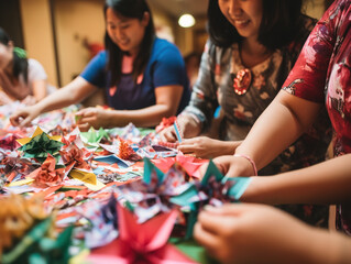 a group of women from different Asian backgrounds come together to craft handmade Christmas decorations. They are using colorful paper, ribbons, and other craft materials to create beautiful ornaments