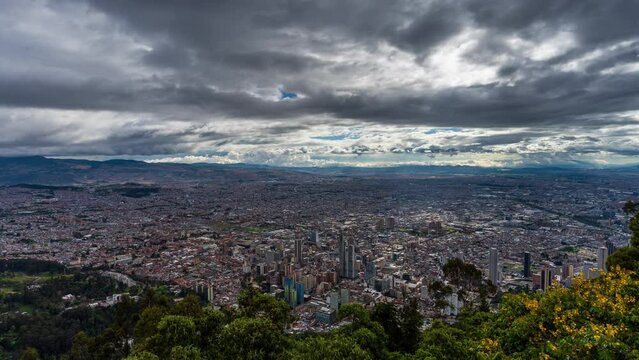 Timelapse from a scenic vantage point overlooking the cityscape of Bogota, during a dramatic cloudy day. Bogota is a sprawling Colombian capital and one of the largest cities in South America