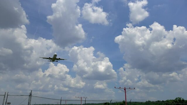 Camera Following Airplane Low Overhead on Approach to Landing at Airport