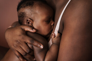 Beautiful sleeping african baby huddling to mother