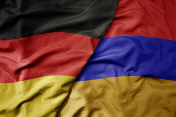 big waving realistic national colorful flag of germany and national flag of armenia .