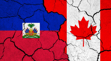 Flags of Haiti and Canada on cracked surface - politics, relationship concept