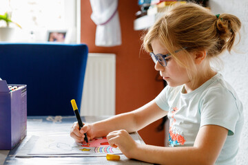 Cute Little Preschooler Child Drawing at Home. Happy Girl with Colorful Felt Pens. Hobby for...