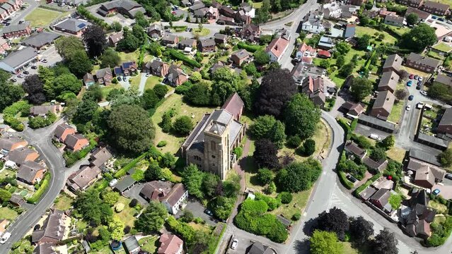 Rotating aerial shot of a church in an English village setting