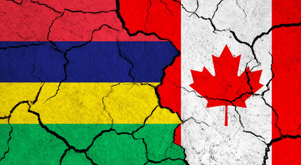 Flags of Mauritius and Canada on cracked surface - politics, relationship concept