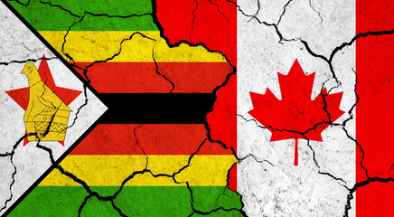 Flags of Zimbabwe and Canada on cracked surface - politics, relationship concept