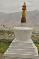 A white stupa with a beautiful Padum (Zanskar Valley) in the background. 