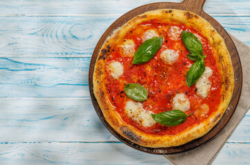 Margarita pizza with tomatoes, mozzarella cheese and basil