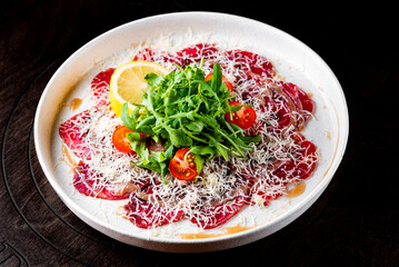 Beef carpaccio with arugula and cheese