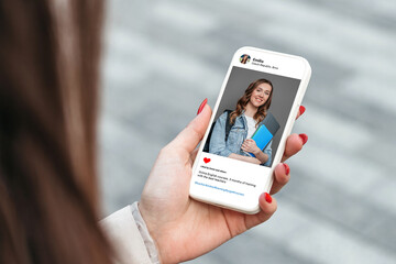 Woman looking at beautiful model's photo on mobile phone. education concept