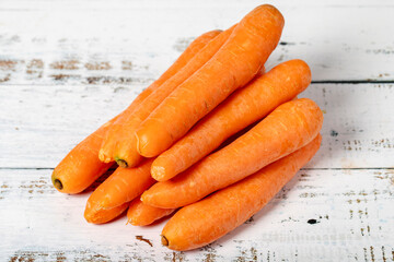 Carrot on a white wood background. Fresh carrot harvest season concept. Vegetables for a healthy diet. Close up