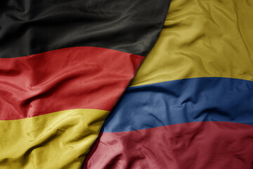 big waving realistic national colorful flag of germany and national flag of colombia .