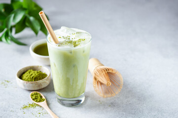 Ice Matcha Latte Green Tea In Glass Cup On Grey Concrete Background. Healthy Refreshing Summer Drink