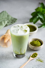 Obraz na płótnie Canvas Ice Matcha Latte Green Tea In Glass Cup On Grey Concrete Background. Healthy Refreshing Summer Drink