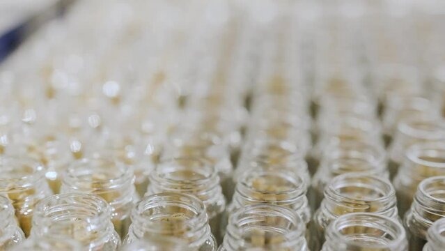 Dolly shot along white label Cannabis joints in California production line