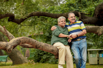 Naklejka na ściany i meble happy Indian senior couple together spending time at park.