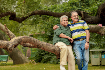 happy Indian senior couple together spending time at park.